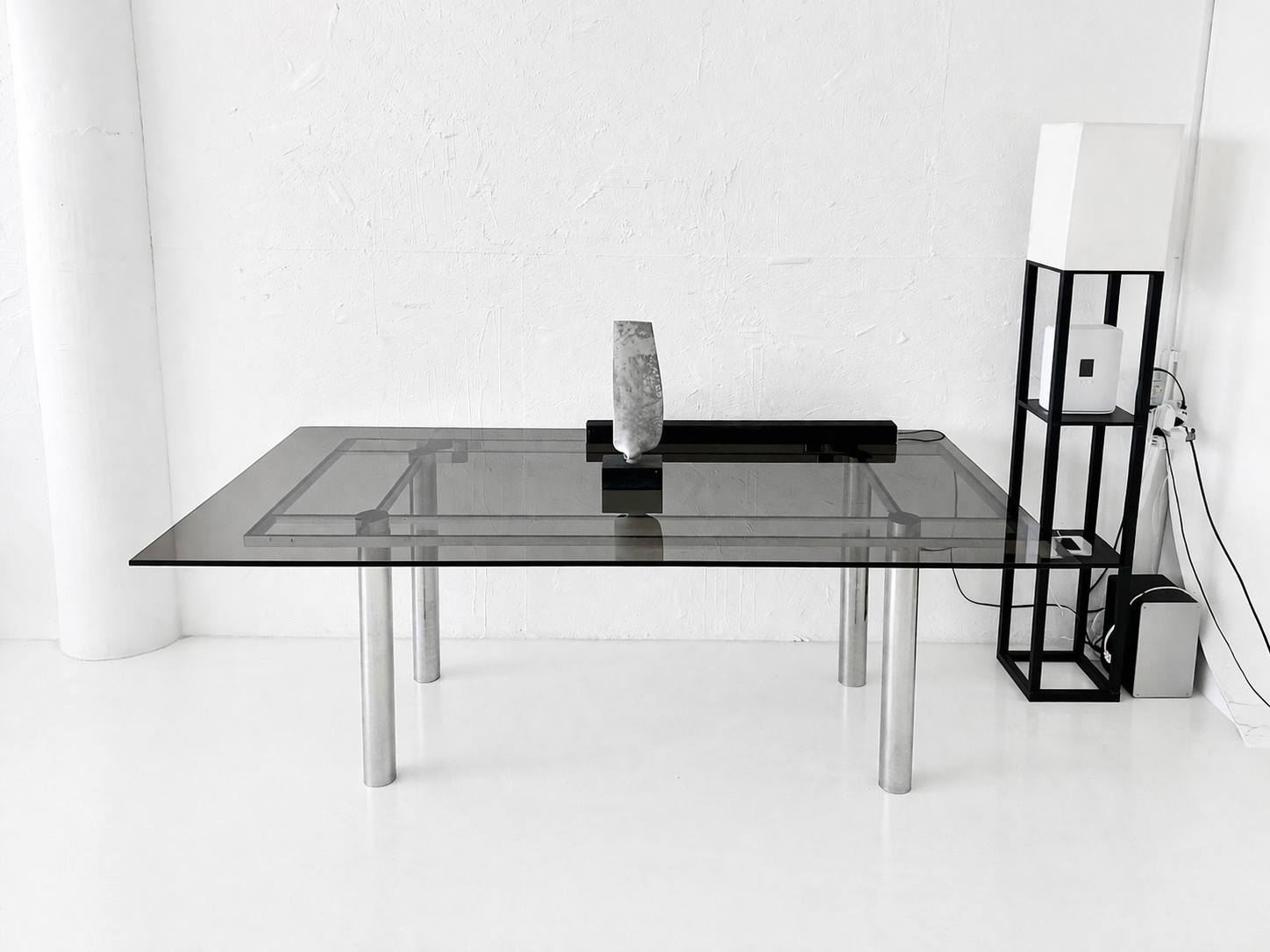Corner of Axcer Studio with chair and side table near window