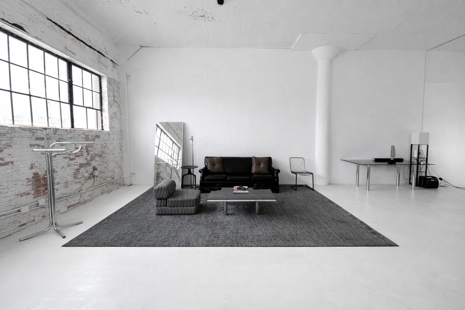 Axcer Studio seating area with leather sofa and rug