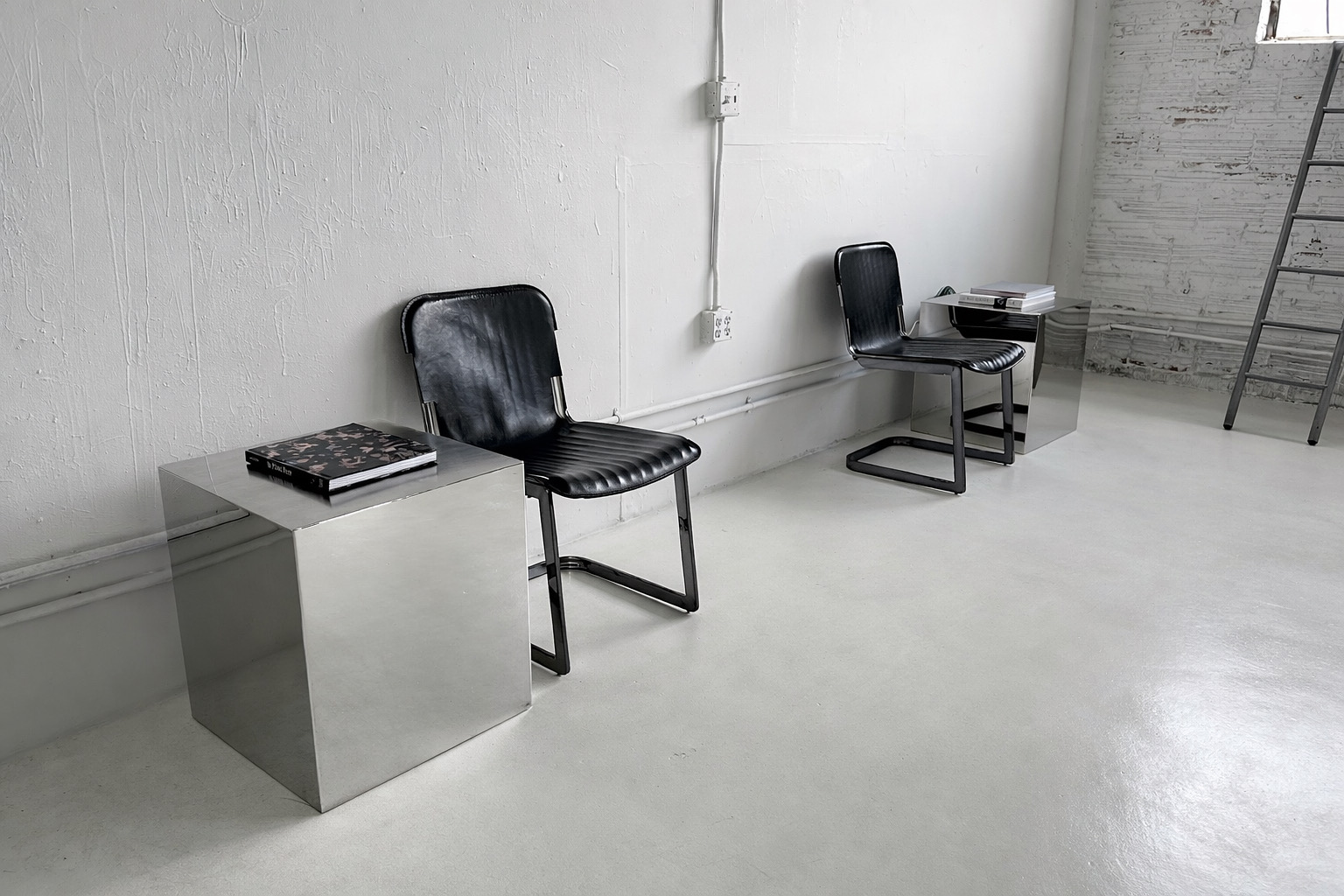 Seating and side tables along the wall at Axcer Studio