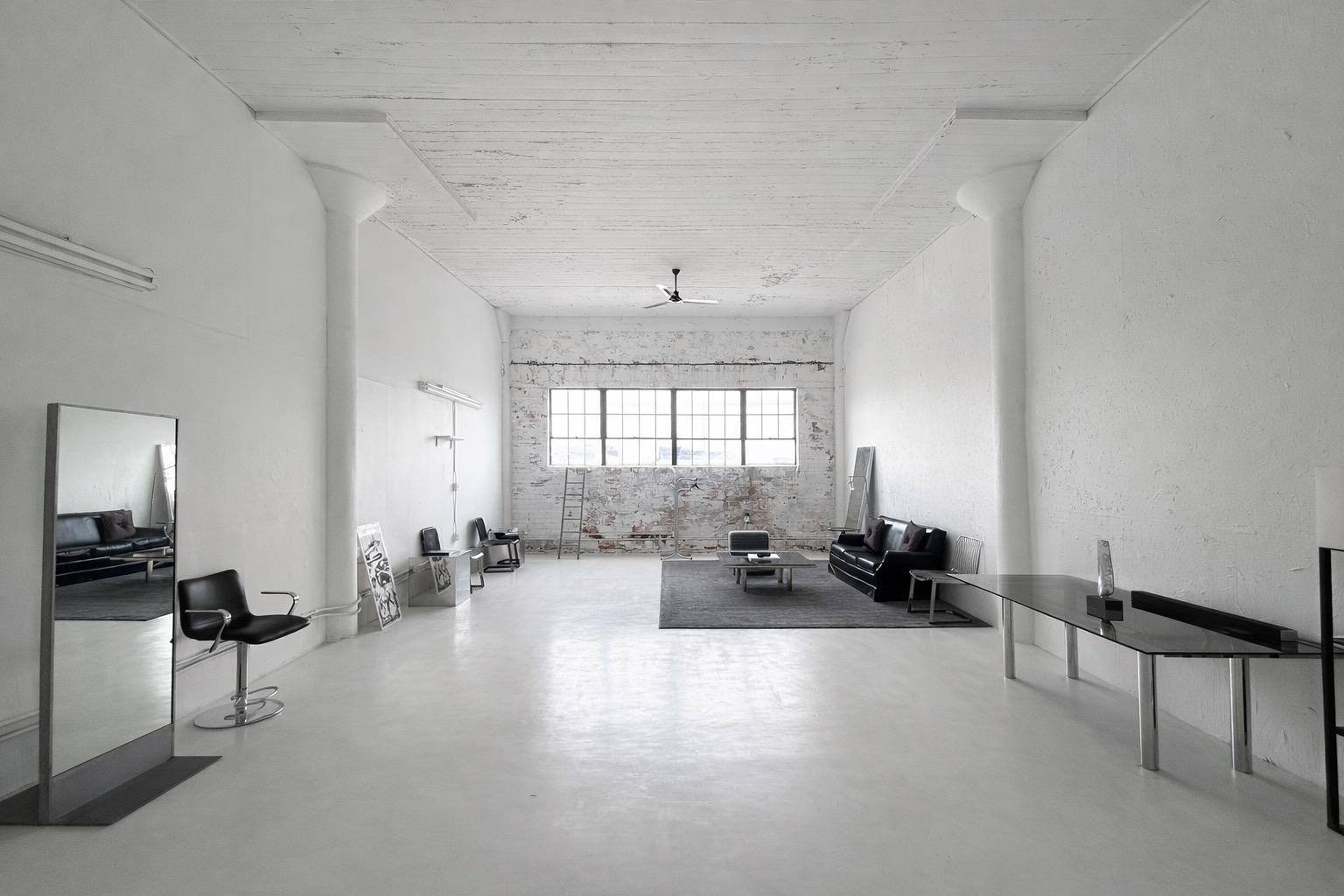 Axcer Studio photography space with brick wall and large window